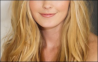 Bailey Rayne strips her pink t-shirt and panties and poses nude in bed